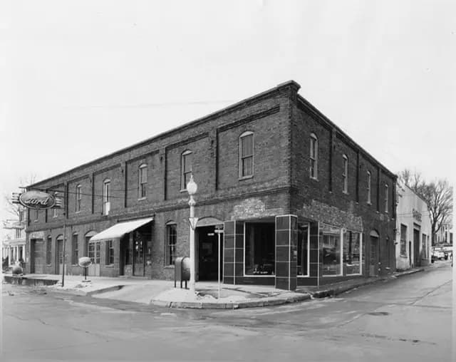 Black-and-white photo of the building as a Ford dealership