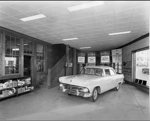 Ford showroom inside the building with a 1950s Ford on display